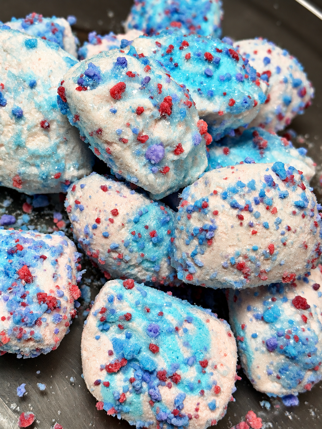 Cotton candy freeze dried taffy pieces topped with glaze and cotton candy crunch