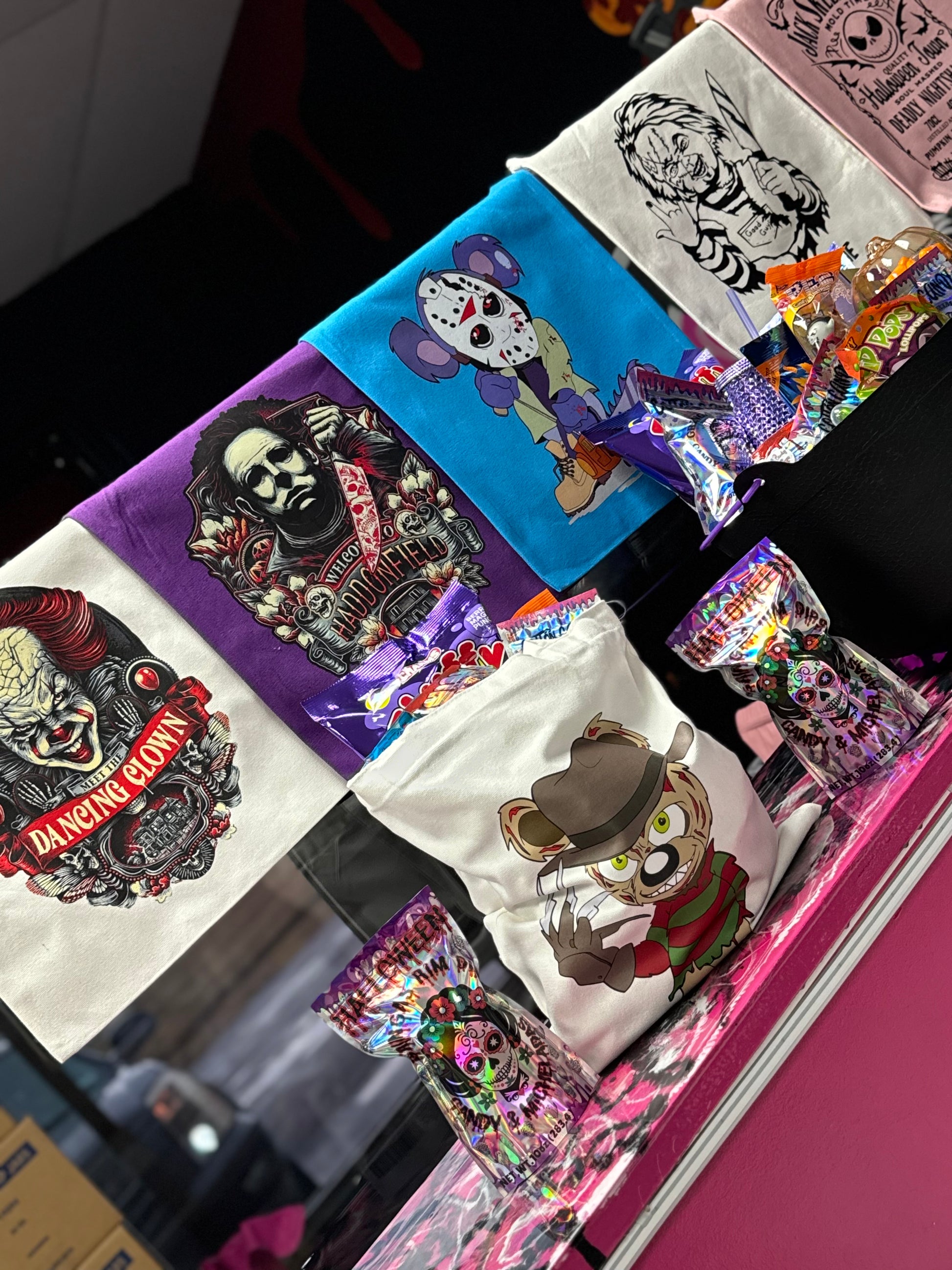 Halloween candy surprise buckets and totes filled with assorted spooky-themed candies, cotton candy, and mystery treats.