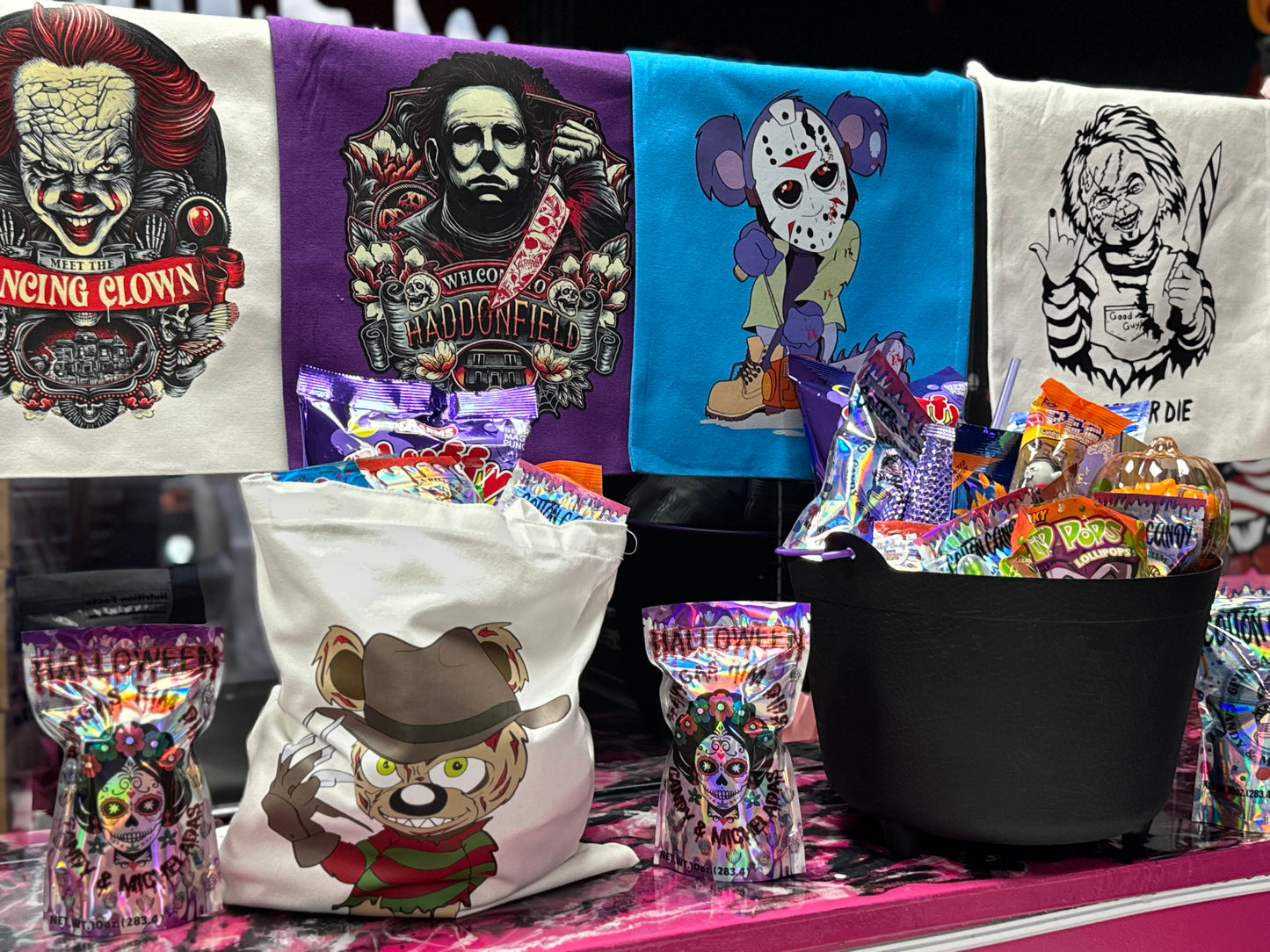 Halloween candy surprise buckets and totes filled with assorted spooky-themed candies, cotton candy, and mystery treats.