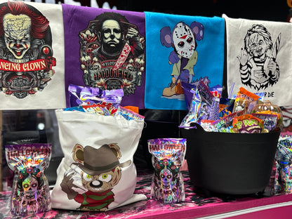 Halloween candy surprise buckets and totes filled with assorted spooky-themed candies, cotton candy, and mystery treats.