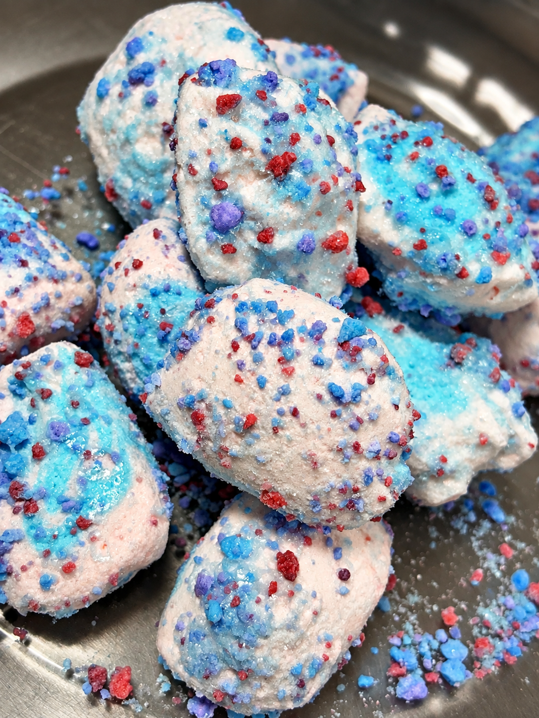 Cotton candy freeze dried taffy pieces topped with glaze and cotton candy crunch