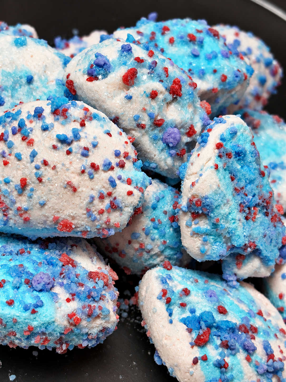 Cotton candy freeze dried taffy pieces topped with glaze and cotton candy crunch