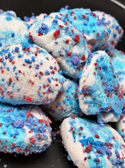 Cotton candy freeze dried taffy pieces topped with glaze and cotton candy crunch