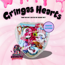 "Gringa’s Heart Candy Gift Box mockup featuring a clear heart-shaped container filled with assorted candies, pink shredded paper, and branded labels. Text reads 'Gringas Hearts – Candy That Says I Love You (or I Deserve This)' with a 'Limited Batches!' badge on a pink swirl background and Queen Gringa’s logo at the bottom."