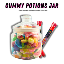 Glass Deadly Potions jar filled with assorted Halloween gummy candies, paired with two sour candy ooze tubes, spooky limited edition Halloween candy set.