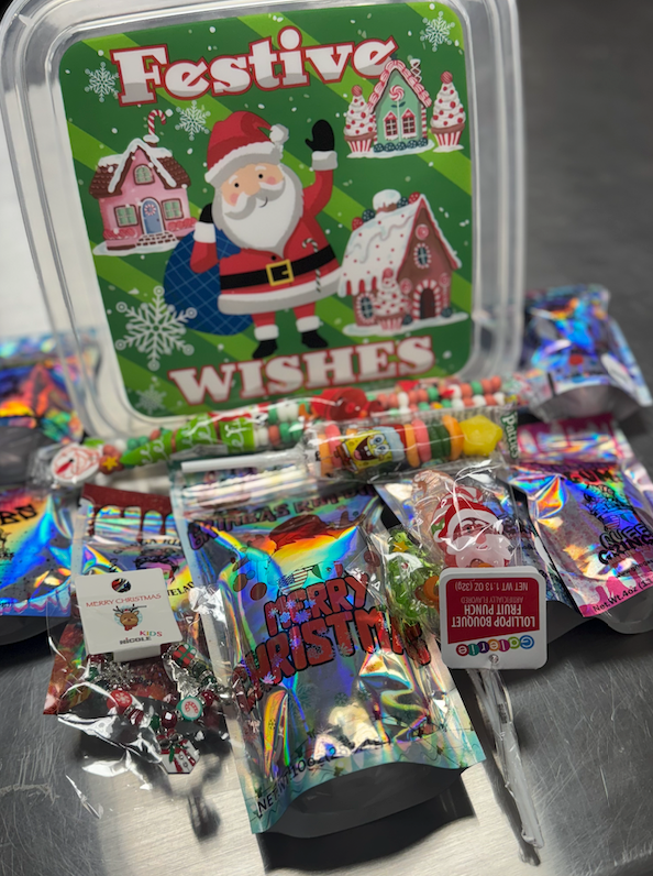 Festive Wishes Holiday Candy Box filled with Gringa candies, holiday mix, and Christmas extras in a reusable Santa-themed container.