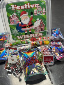 Festive Wishes Holiday Candy Box filled with Gringa candies, holiday mix, and Christmas extras in a reusable Santa-themed container.