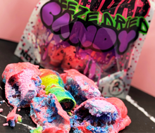 Colorful candy with a branded packaging on a black surface.